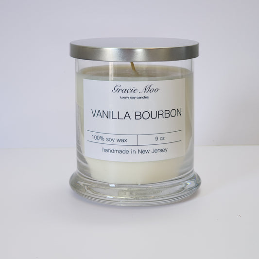 Vanilla Bourbon scented candle by Gracie Moo Candles with a simple glass container and a natural wax finish.