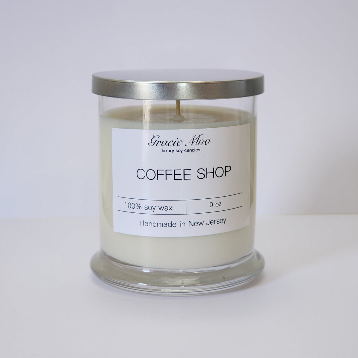 Gracie Moo Candles coffee shop status candle with cozy design, perfect for creating warm ambiance in any space.