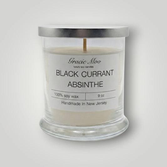 Black Currant Absinthe scented candle by Gracie Moo Candles, featuring a black candle with a smooth surface and elegant label.