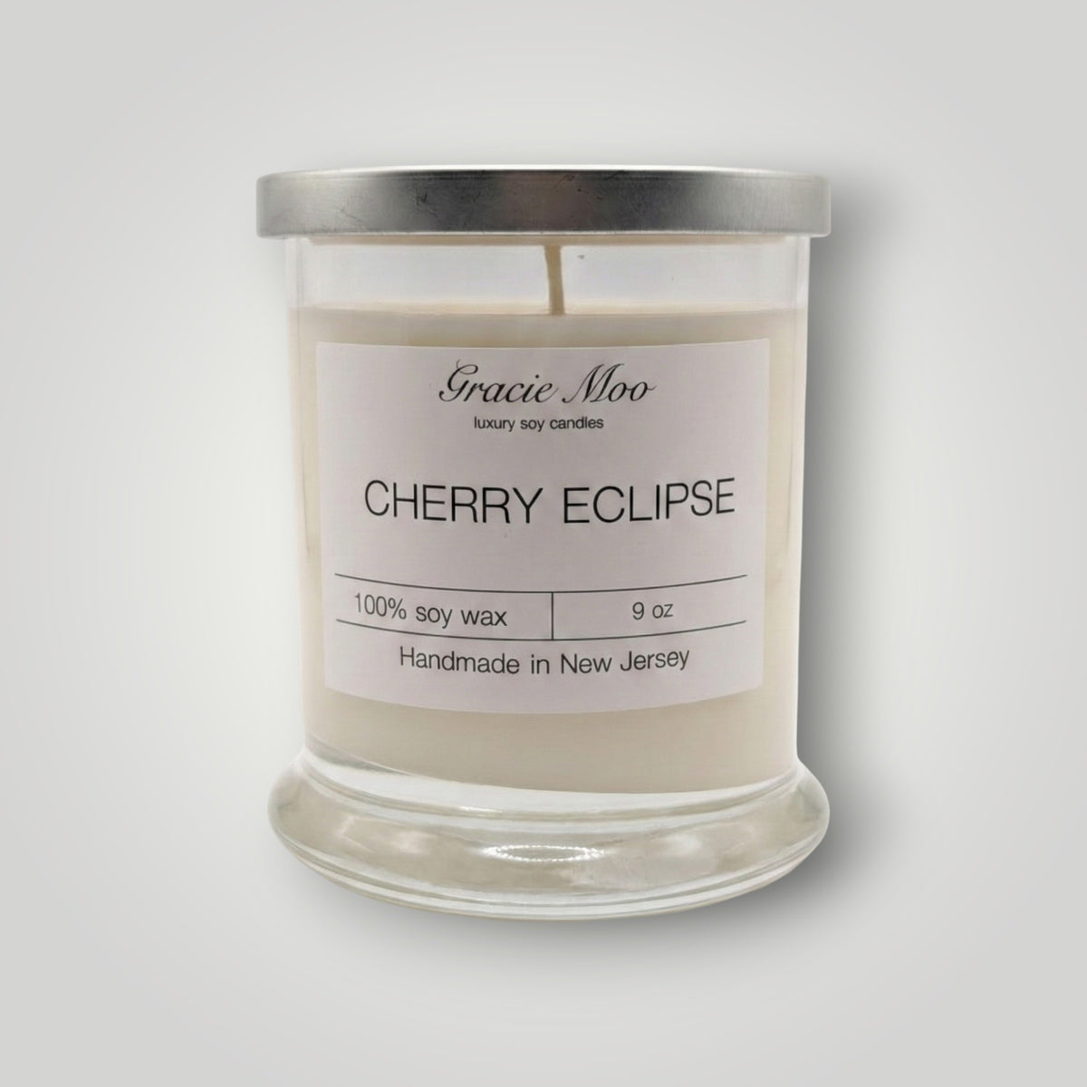 Cherry Eclipse Status candle by Gracie Moo Candles with a sleek black and red design, perfect for ambient lighting.