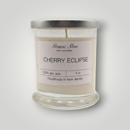 Cherry Eclipse Status candle by Gracie Moo Candles with a sleek black and red design, perfect for ambient lighting.