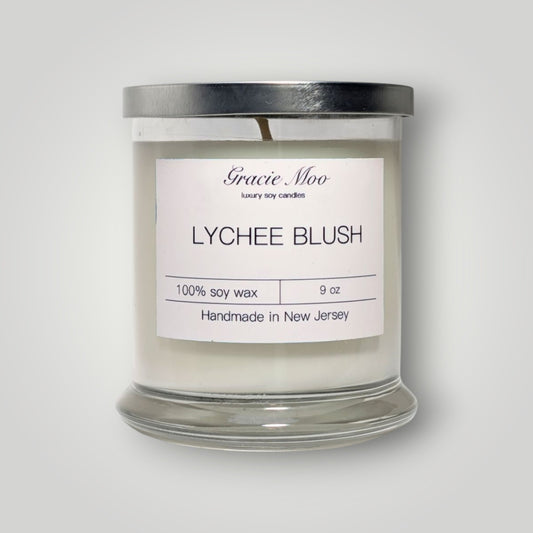 Lychee Blush Status Candle by Gracie Moo Candles featuring a soft pink wax with a natural cotton wick.