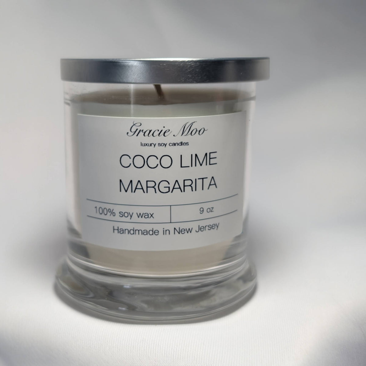 Gracie Moo Candles Coco Lime Margarita status candle with tropical lime and coconut scent in a decorative candle holder.