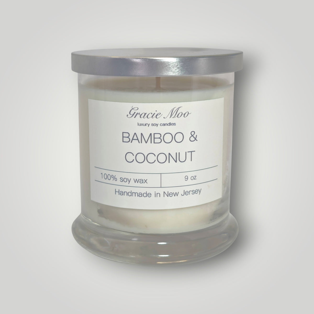 Bamboo and coconut scented candle from Gracie Moo Candles, with a natural bamboo and coconut design in a glass jar.