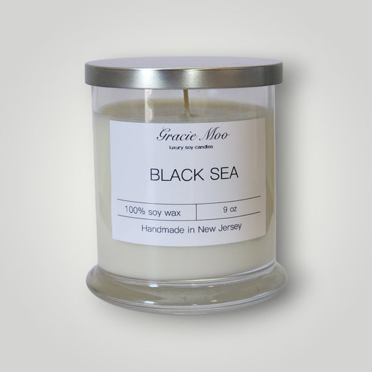 Black Sea Status Candle by Gracie Moo Candles featuring a sleek black design and elegant wax finish.