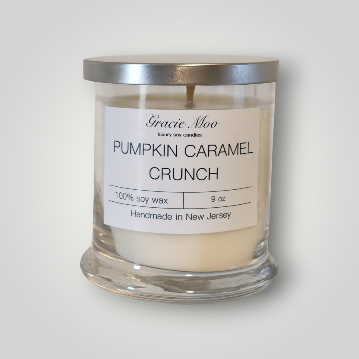 Pumpkin Caramel Crunch Status Candle by Gracie Moo Candles, featuring a warm orange hue and a textured surface.