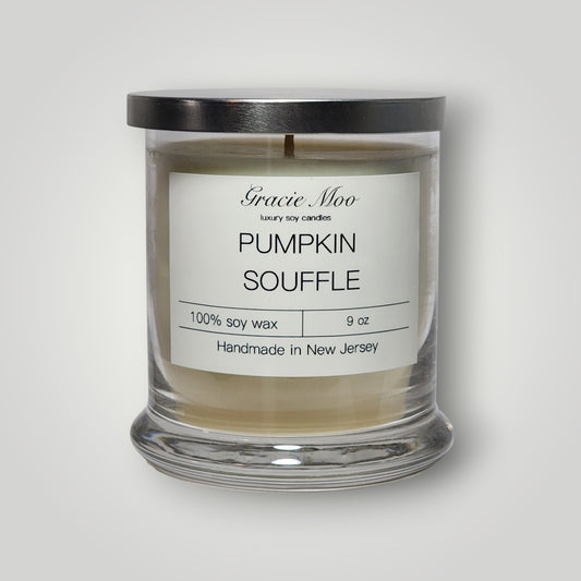 Pumpkin Soufflé scented candle by Gracie Moo Candles in a glass jar with a pumpkin-themed label.