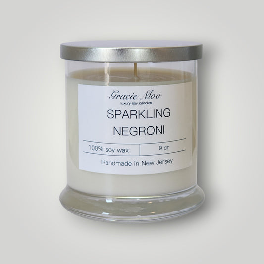 Sparkling Negroni scented candle by Gracie Moo Candles with a stylish glass jar and elegant label design.