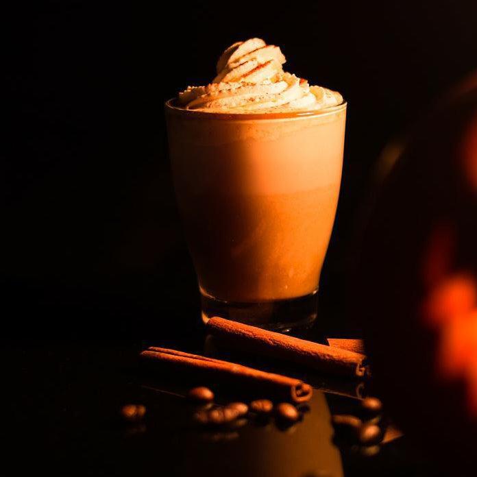 Toasted Pumpkin Spice candle by Gracie Moo Candles in a decorative glass jar with warm autumn tones.